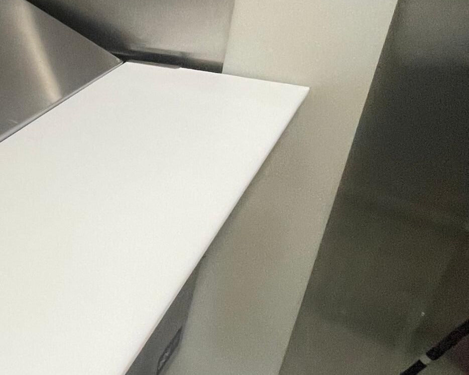high-quality white cutting board on a metallic refrigerator